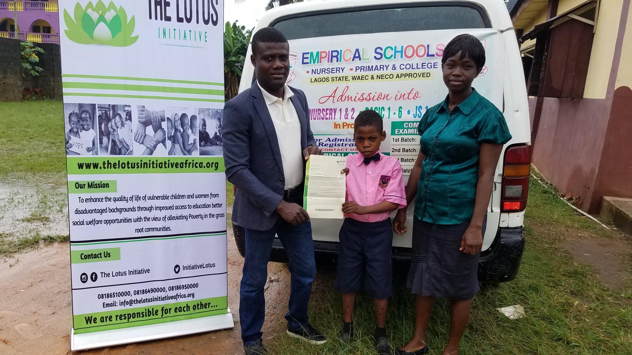 Lotus Initiative Program Manager presenting scholarship offer letter to Master Great Chidubem with a staff of Empirical College Staff.