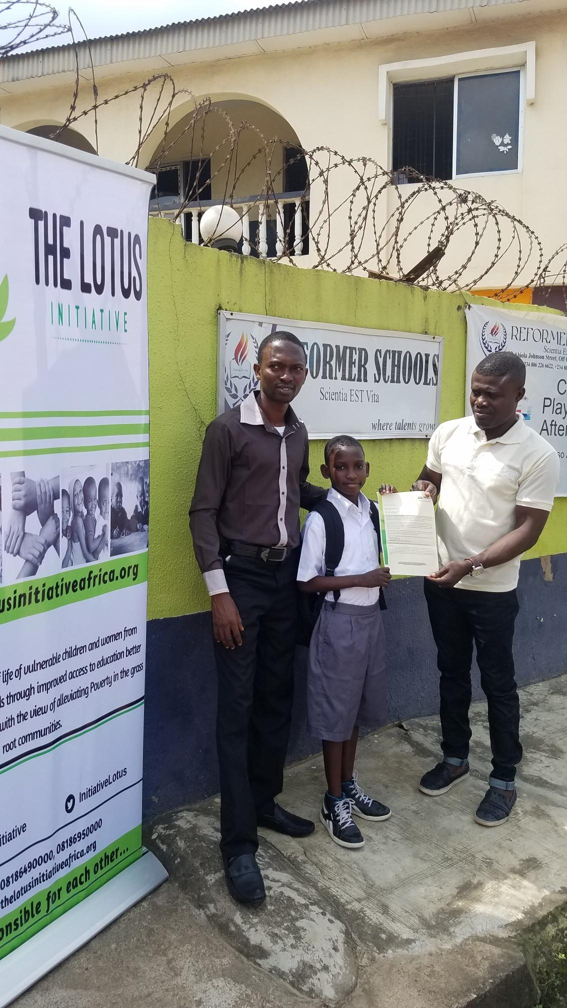 Lotus Initiative Program Manager presenting scholarship offer letter to Master Samuel Sham Adams with a staff of Reformer College.