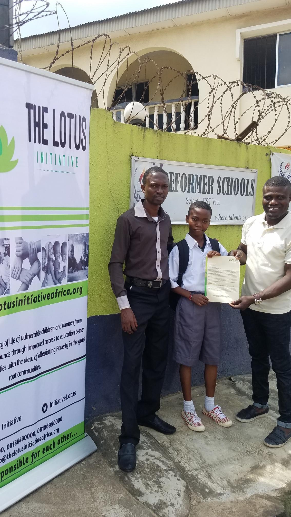 Lotus Initiative Manager presenting scholarship offer letter to Master Samuel Kareem of Reformer College with a staff.