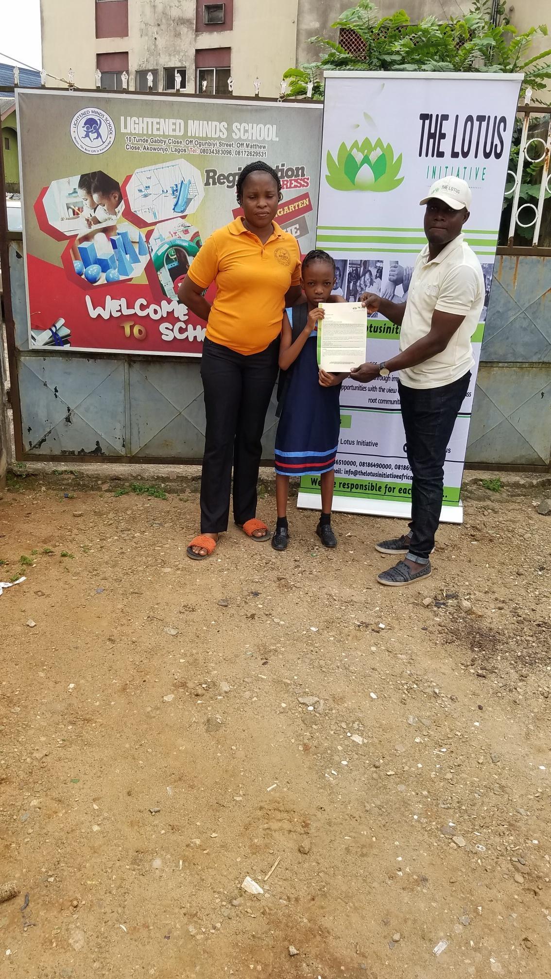 Presentation of scholarship letter to Miss. Joy Akaaba of Lightened Mind Private School