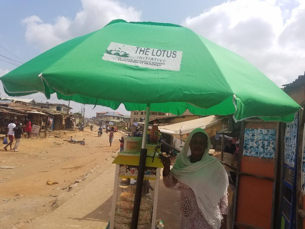 Presentation of Lotus Umbrella to a Popcorn Vendor Mrs. Bukky Banire