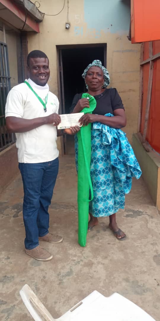 Caring for the elderly... Lotus Initiative Program Manager Presenting Cash Gift to an Elder.